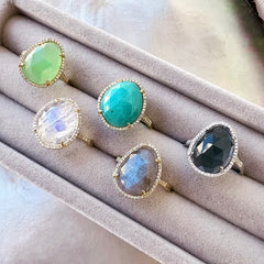 A selection of organic shaped colored stone rings in solid 14k gold with natural diamonds