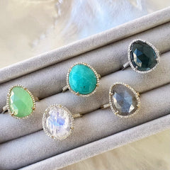 A selection of organic shaped colored stone rings in solid 14k gold with natural diamonds