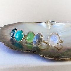 A selection of organic shaped colored stone rings in solid 14k gold with natural diamonds
