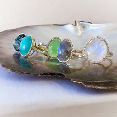 A selection of organic shaped colored stone rings in solid 14k gold with natural diamonds