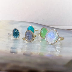 A selection of organic shaped colored stone rings in solid 14k gold with natural diamonds