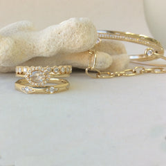 hand made chain bracelet in gold and diamonds, stacked and layered with other liven pieces